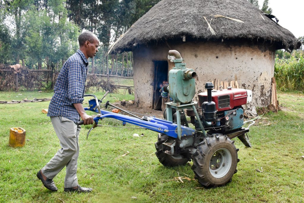 Temam Mama drives a two-wheel tractor to the irrigation area. (Photo: Simret Yasabu/CIMMYT)