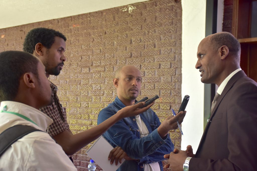 CIMMYT’s representative in Ethiopia, Bekele Abeyo, gives an interview for Ethiopian media during the conference. (Photo: Jérôme Bossuet/CIMMYT)