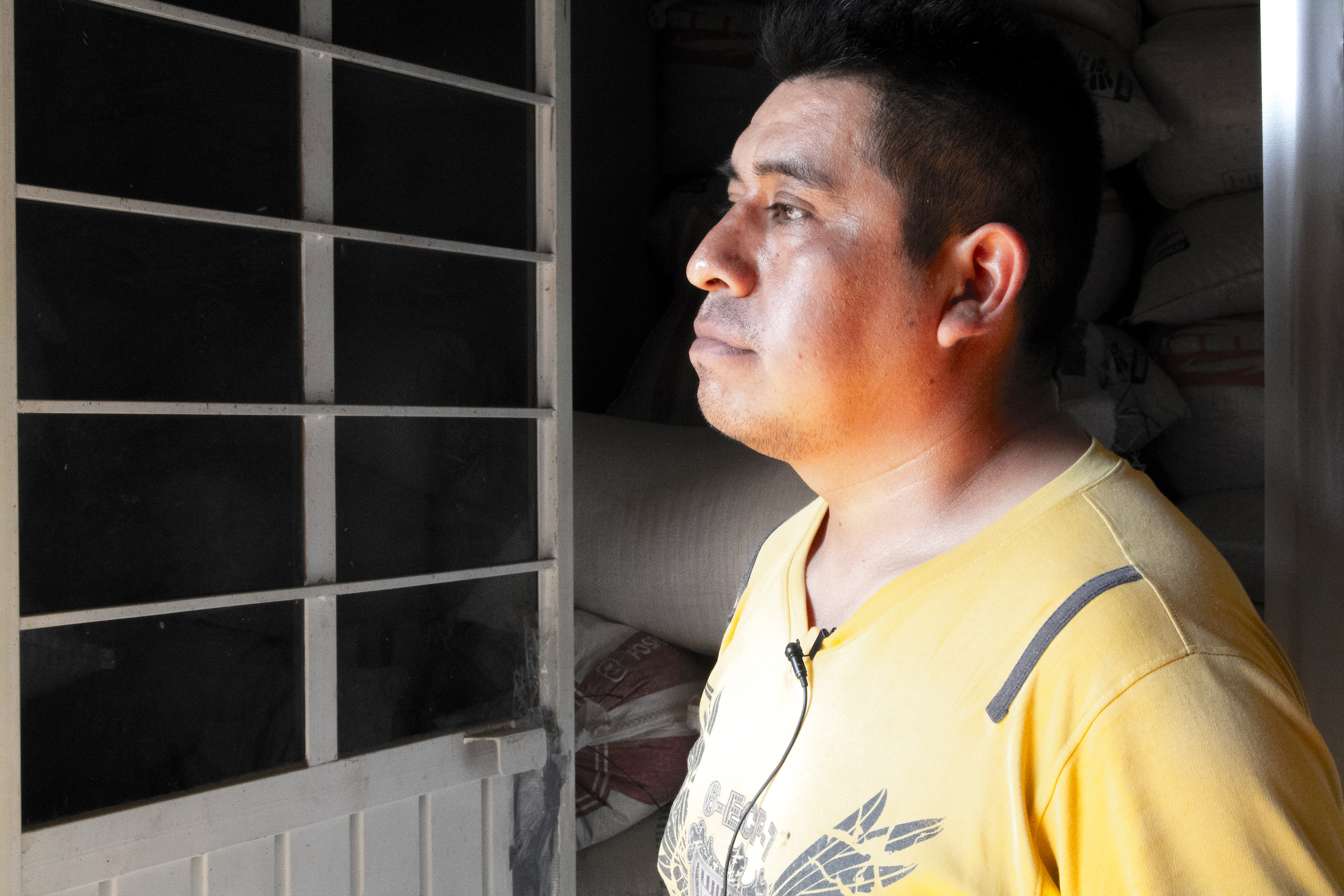 The family’s son, Isaac Juarez Oliveros, stands outside the maize storage room where they store and dry their harvested maize for sale and consumption. (Photo: E. Orchardson/CIMMYT)