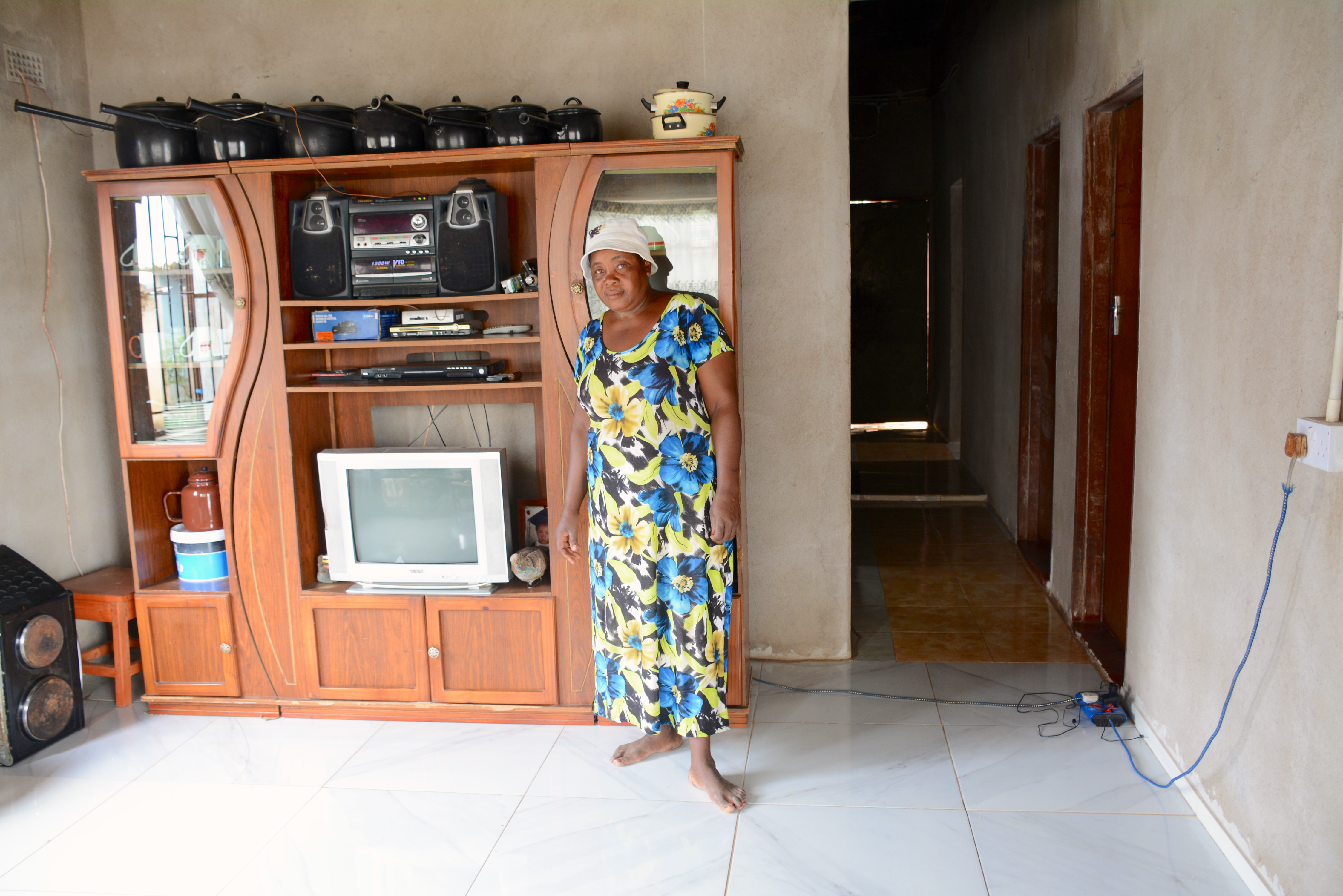 Lilian Chimbadzwa shows the house they were able to build in 2013 using proceeds from lablab sales. (Photo: Shiela Chikulo/CIMMYT)