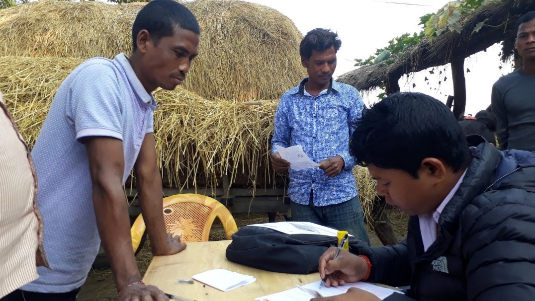 A farmer processes a loan through Laxmi Bank's branchless banking system in Kailali district, Nepal. (Photo: Suman Khanal/CIMMYT)