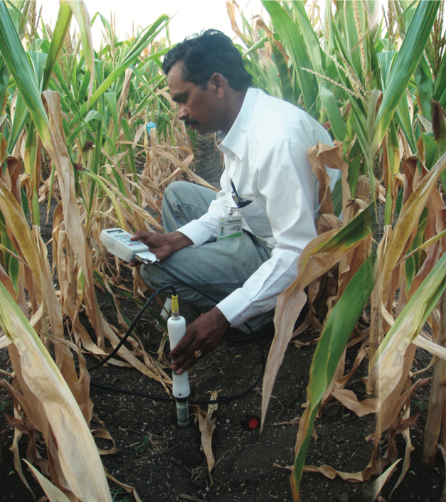 A researcher uses a vertical probe to measure moisture at different soil depths. (Photo: CIMMYT)