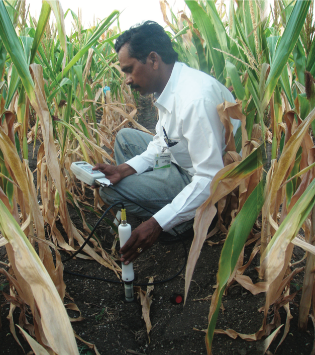 A researcher uses a vertical probe to measure moisture at different soil depths. (Photo: CIMMYT) 