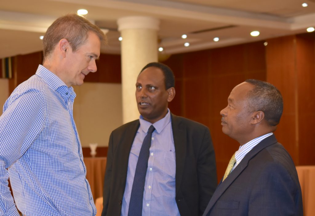 CIMMYT’s Socioeconomics Program Director, Olaf Erenstein (left), talks to Eyasu Abraha, Minister of Agriculture and Natural Resources (center), and Mandefro Nigussie, Director General of the Ethiopian Institute of Agricultural Research.