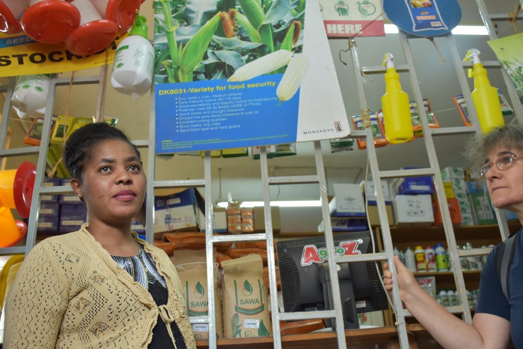 Marianne Banziger (right), CIMMYT's deputy director for research and partnership, listens to a Dryland Seed sales manager during a visit to a farm supplies shop in Machakos, Kenya. (Photo: Jerome Bossuet/CIMMYT)