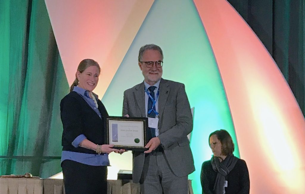 Hans-Joachim Braun (center) receives the Crop Science Society of America Fellow certificate onstage. (Photo: Johanna Franziska Braun/CIMMYT)