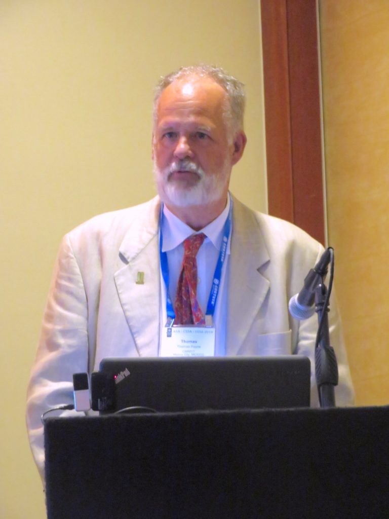 Thomas Payne delivers a presentation at the Crop Science Society of America’s annual Genetic Resources breakfast, where he received the award. (Photo: Kevin Pixley/CIMMYT)