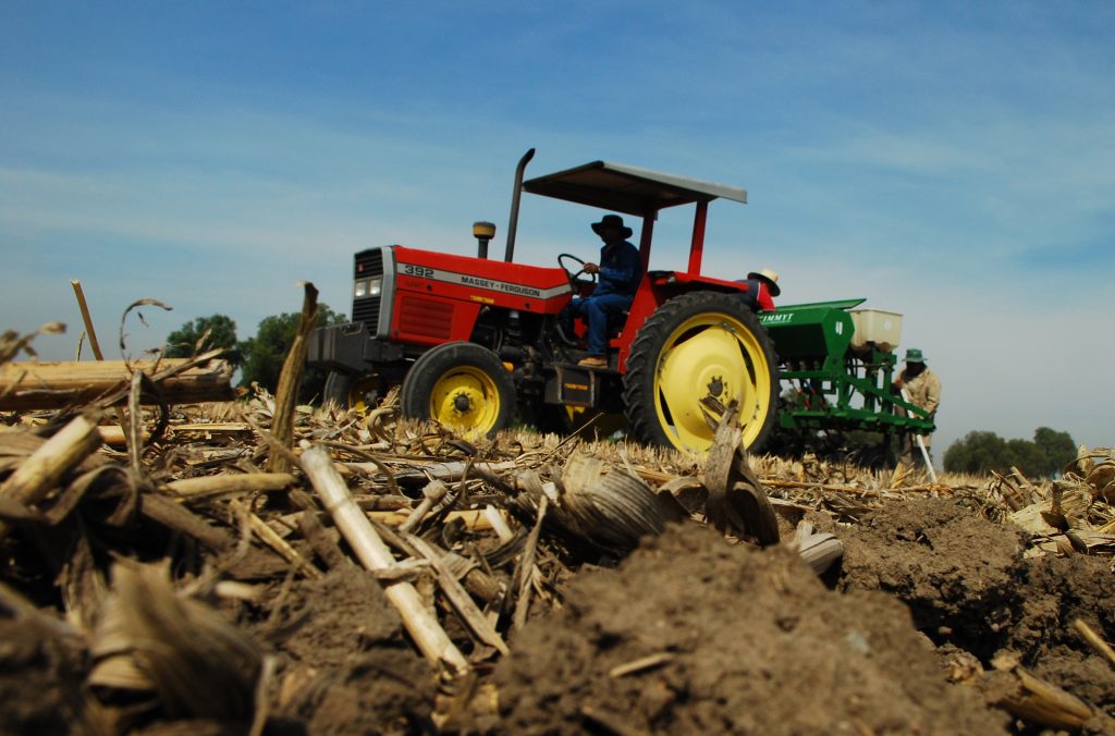 CIMMYT's multi-crop, multi-use zero-tillage seeder at work on a long-term conservation agriculture trial plot at the center's global headquarters in Mexico. Maize crop residues are visible in the foreground. (Photo: CIMMYT)