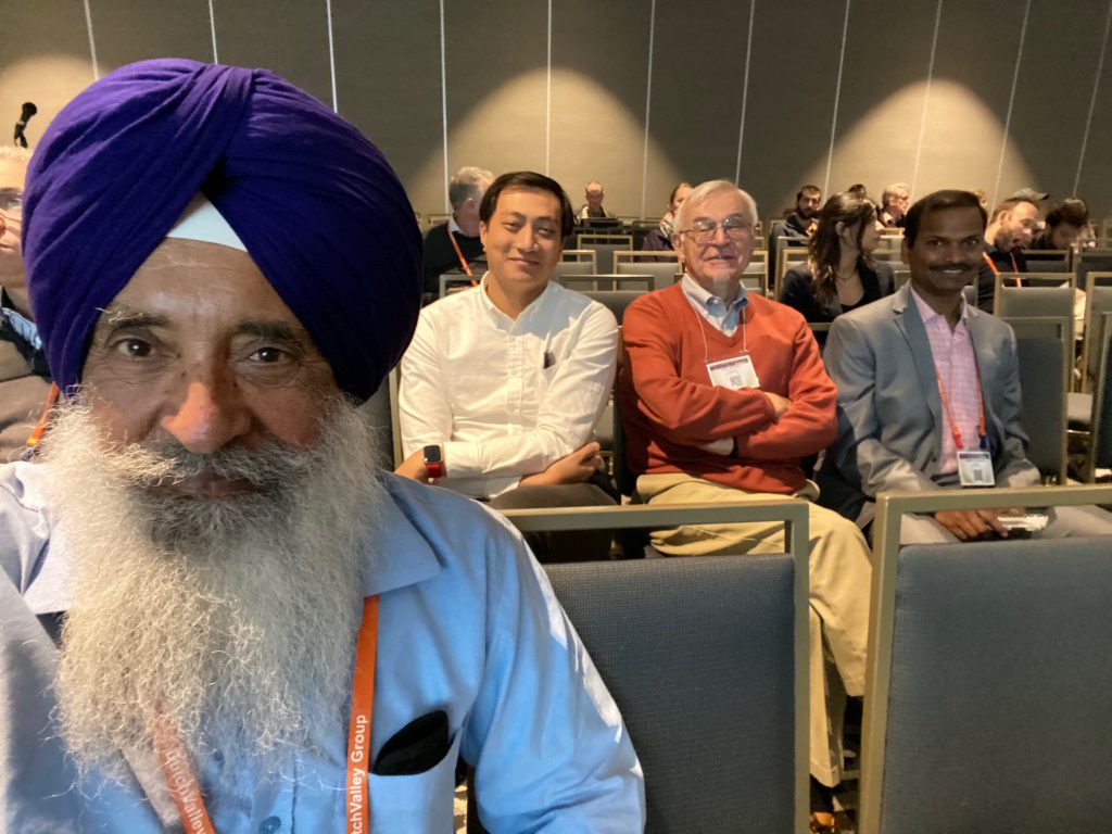 Kanwarpal Dhugga (left) takes a selfie with his colleagues in the background during the PAG conference. (Photo: Kanwarpal Dhugga/CIMMYT)