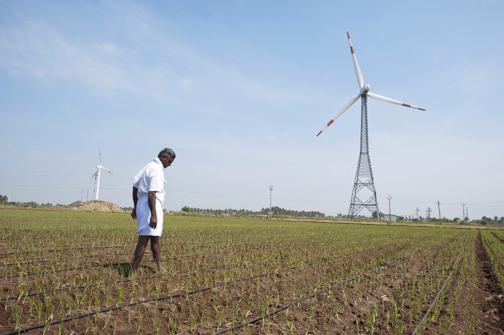 A farmer checks the drip irrigation system at his rice field in India. (Photo: Hamish John Appleby/IWMI)