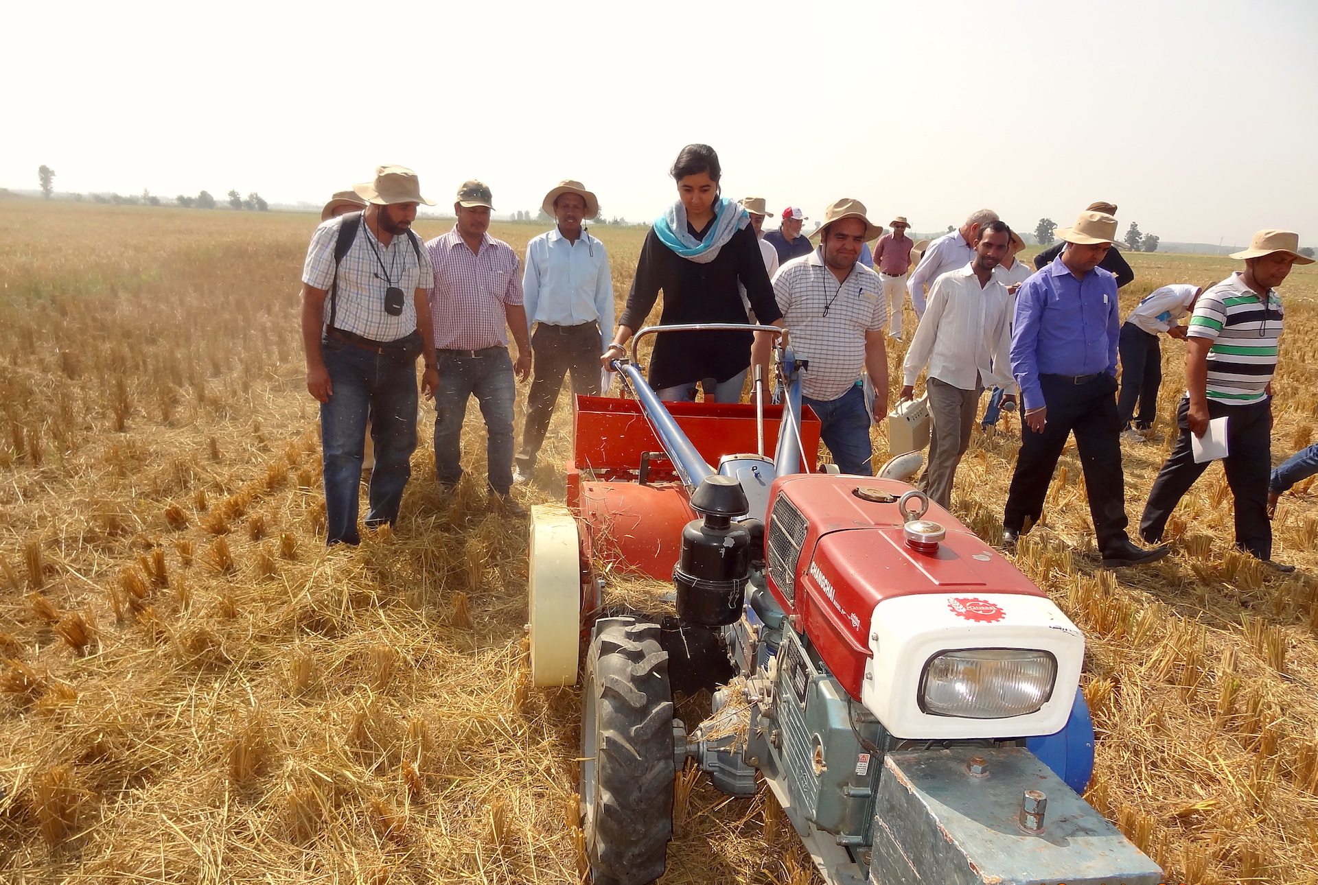 During a conservation agriculture course, a young trainee operates a Happy Seeder mounted on a two-wheel tractor, for direct seeding of wheat in smallholder systems. (Photo: CIMMYT)