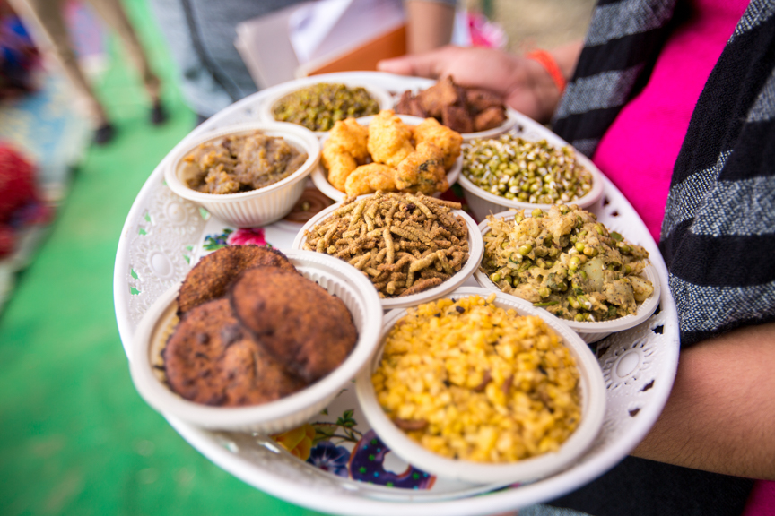 A member of a women farmers group serves a platter of mung bean dishes in Suklaphanta, Nepal. (Photo: Merit Maharajan/Amuse Communication)