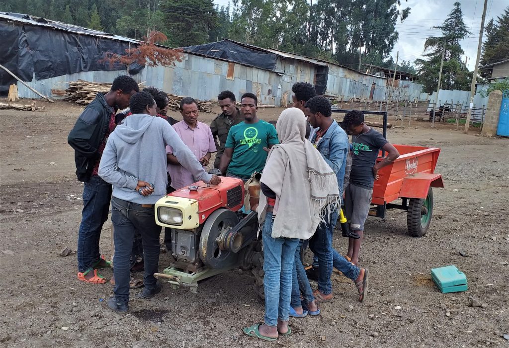 Beyene Chufamo (center, in green t-shirt) provides technical training on operation, safety, repair and maintenance to machinery hire service providers in different CIMMYT operation sites. His participation in small mechanization supply chain enables service providers and farmers to effectively use their machinery and significantly reduce the downtime of their machinery. (Photo: Ephrem Tadesse/CIMMYT)