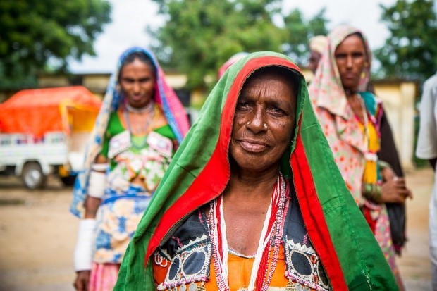 Women walk down road.