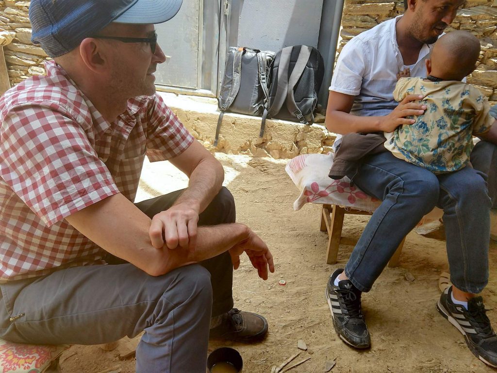 Jordan Chamberlin (left) talks to a farmer in Ethiopia’s Tigray region in 2019, while conducting research on youth outmigration from rural areas. (Photo: Jordan Chamberlin)