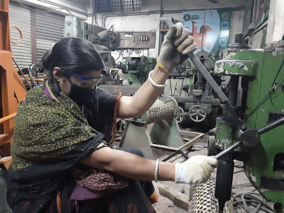Woman works machinery.