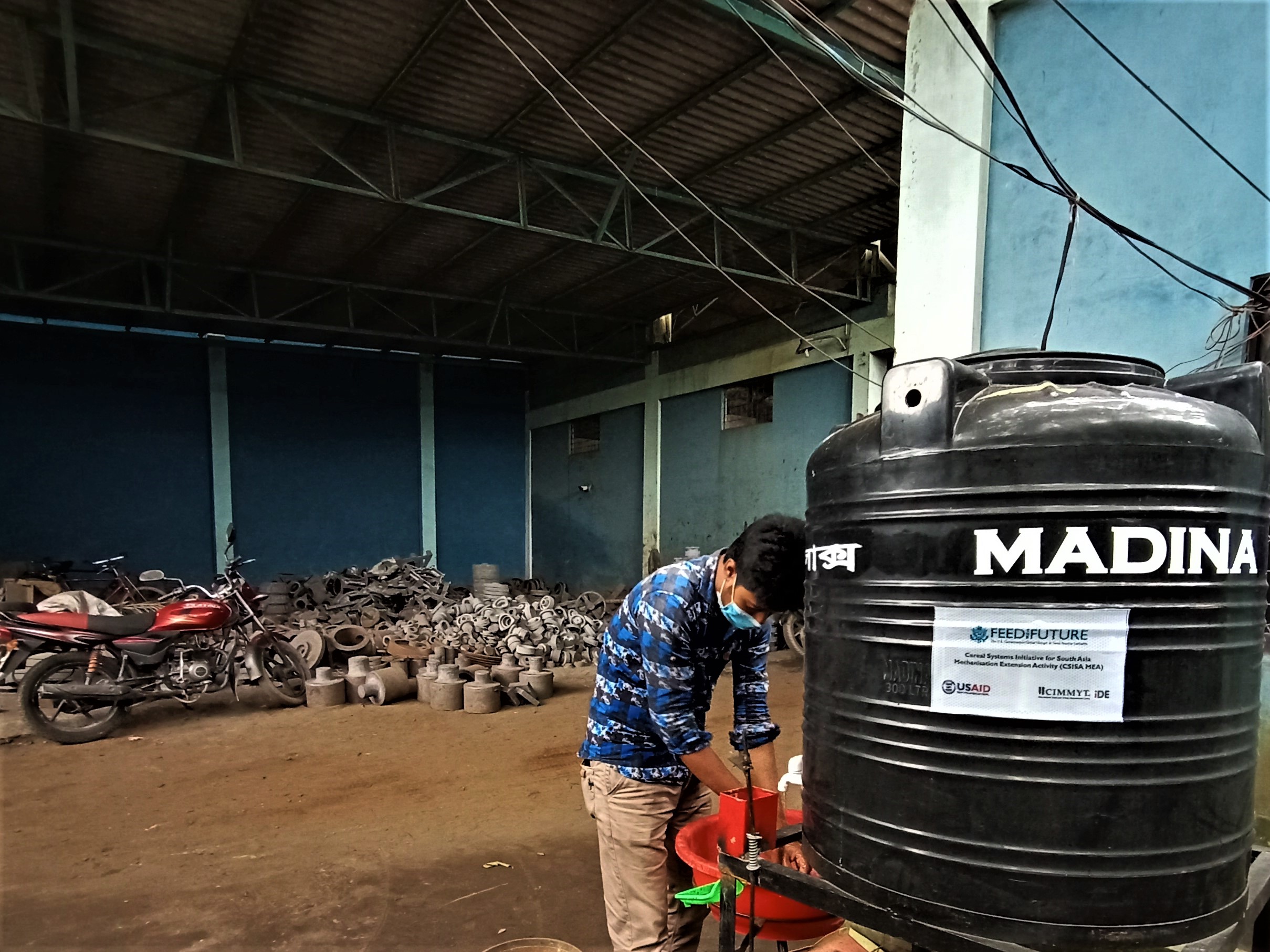 Man washes hands in workshop.