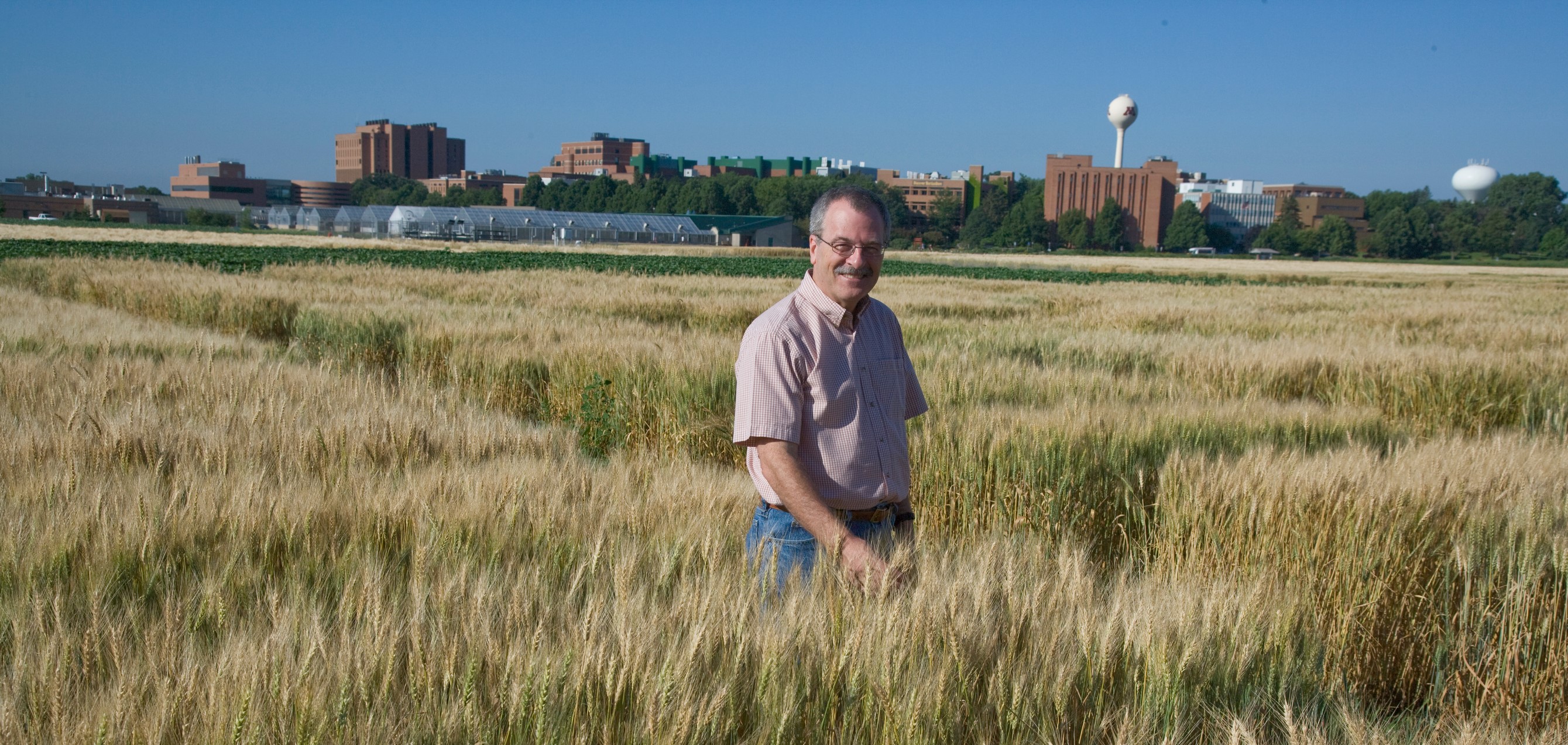Philip Pardey stands in a wheat field. (Photo: David Hansen/University of Minnesota)
