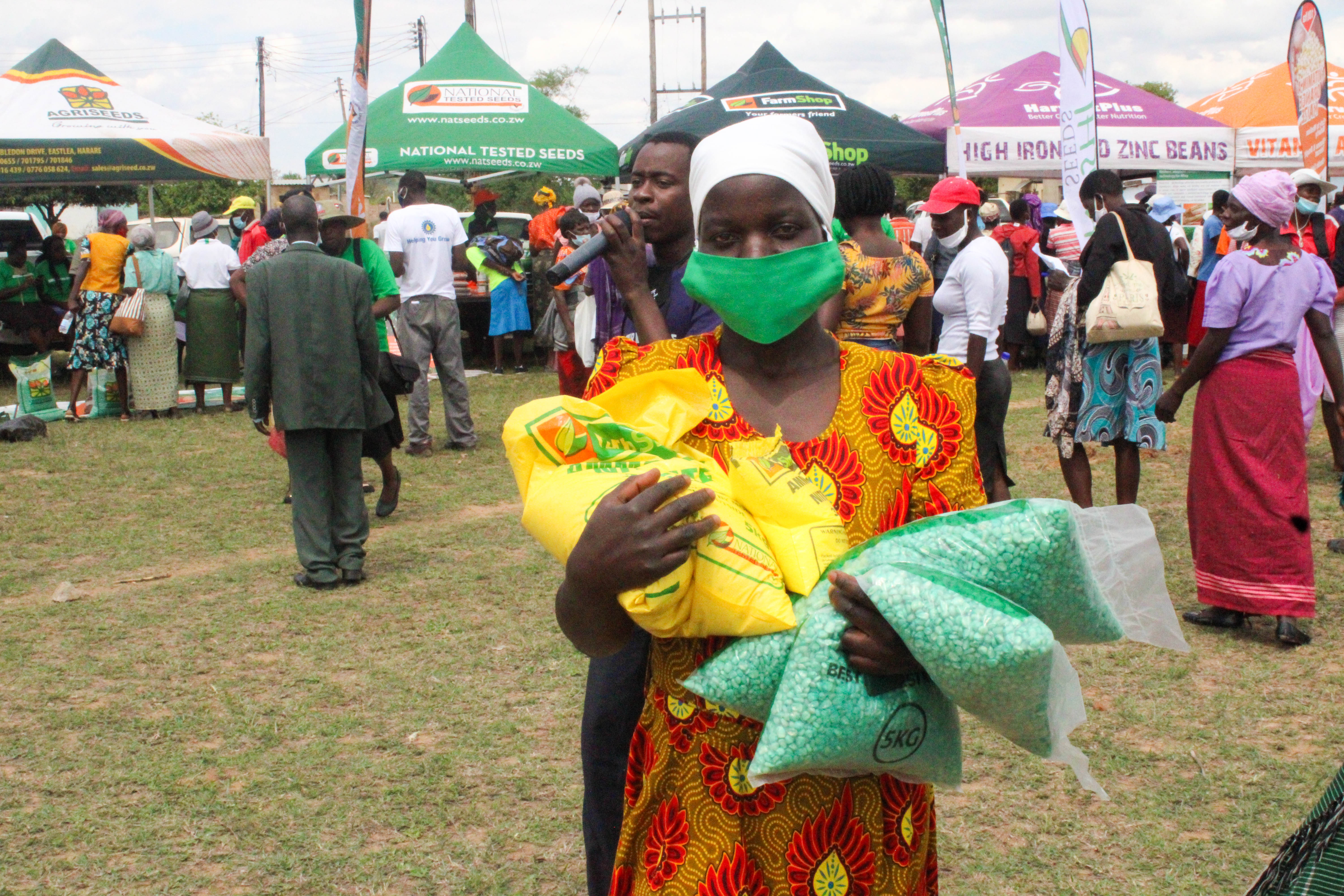 A smallholder farmer displays the products she purchased at a seed fair in Masvingo, Zimbabwe. (Photo: Shiela Chikulo/CIMMYT)