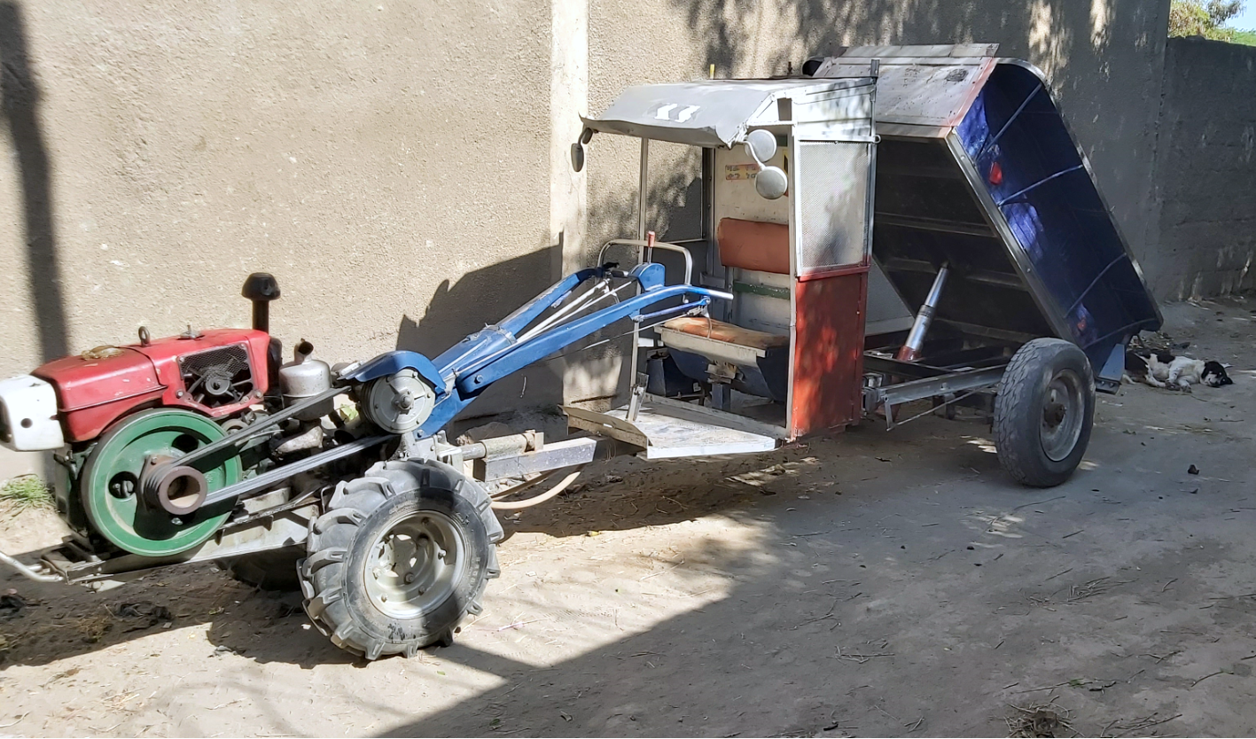 A two-wheel tractor with an improved driver seat and hydraulic tipping trailer system sits in from of Beyene Chufamo’s workshop in Meki, Ethiopia. (Photo: CIMMYT)