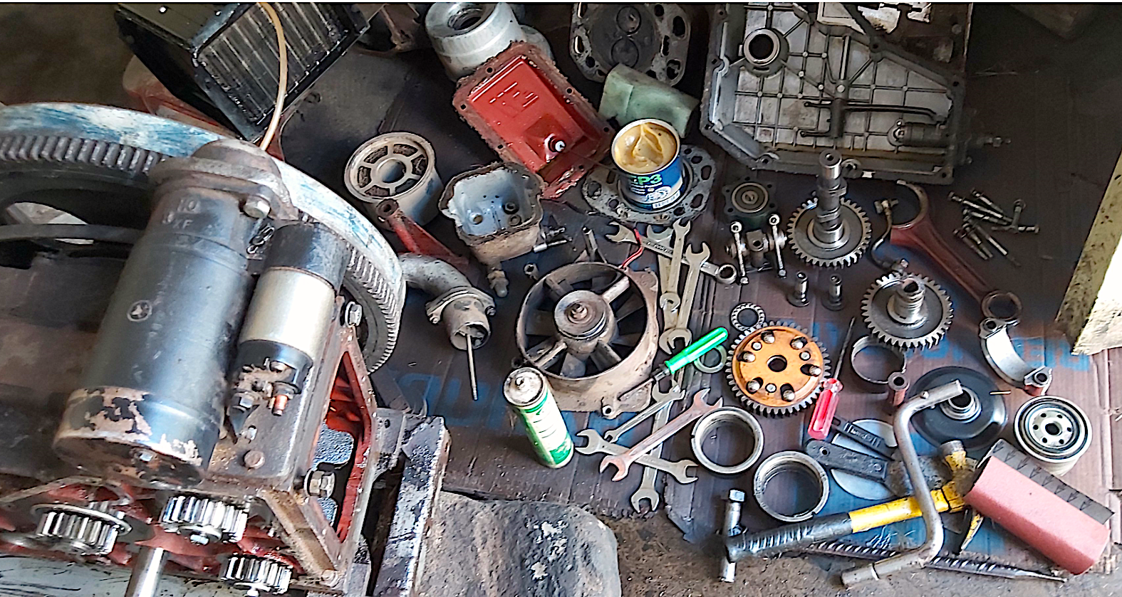 Tools and spare machinery parts lie on the ground during at Beyene Chufamo’s workshop in Meki, Ethiopia. (Photo: CIMMYT)