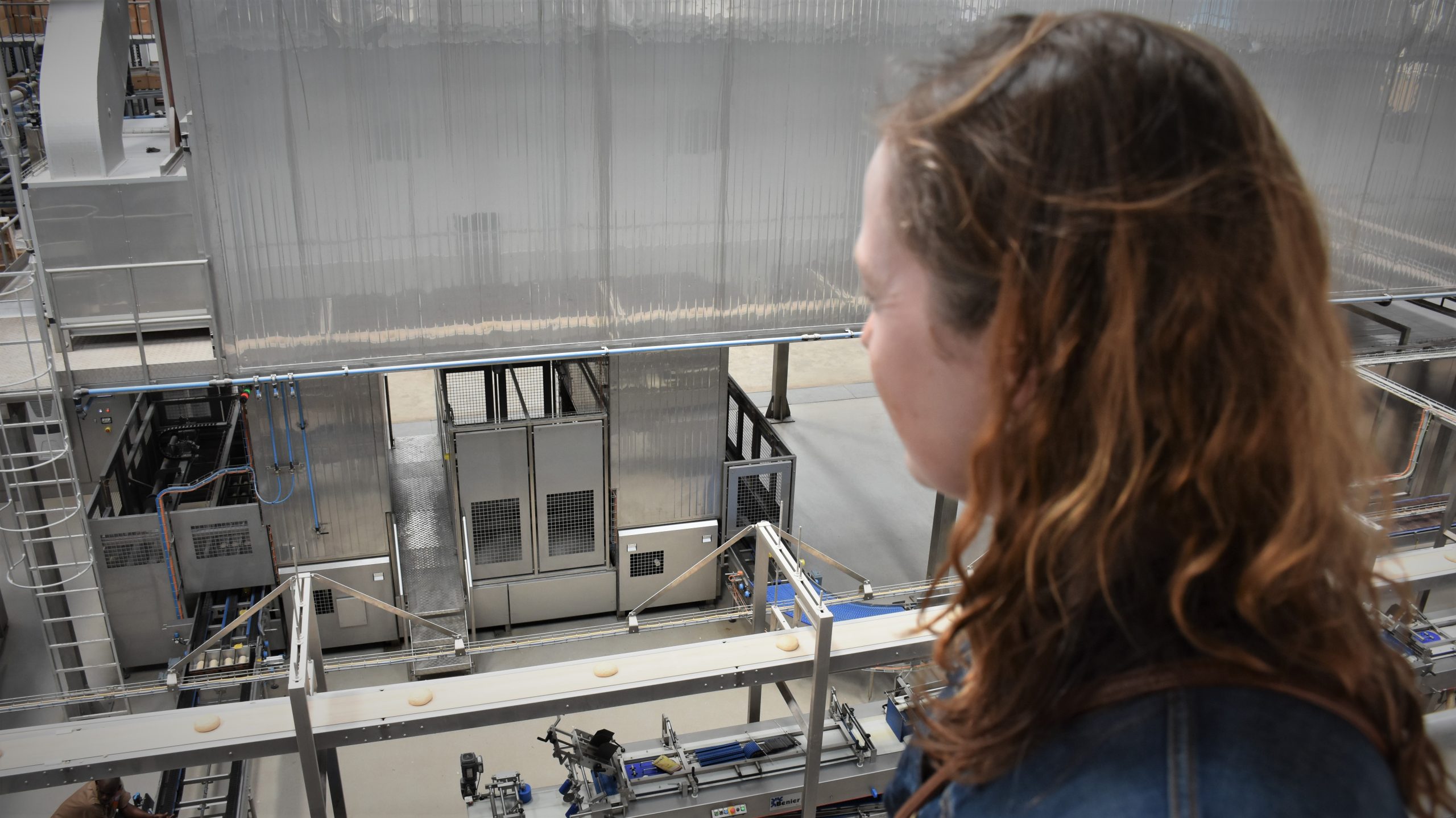 CIMMYT Global Wheat Program director, Alison Bentley, observes the bread making process at an industrial bakery on the outskirts of Nairobi, Kenya. (Photo: Susan Otieno/CIMMYT)