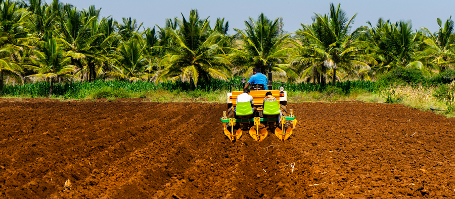 A farmer pulls a row seeder in Benin, West Africa.