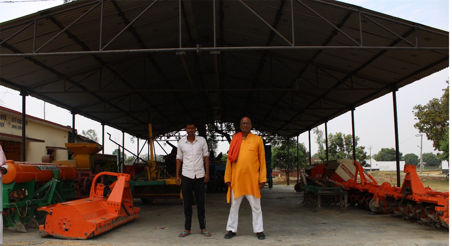 Gangesh Pathak with his father at the custom hiring center which provides custom hiring services to smallholder farmers in the region.