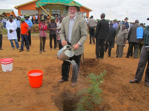 Thomas Lumpkin waters a commemorative tree seedling he planted after the inauguration of the DH Facility in Kiboko. Photo: Wandera Ojanji