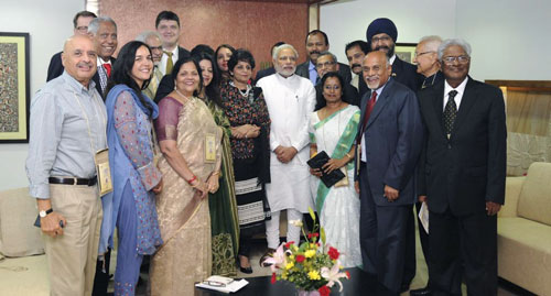 Dr. Sanjaya Rajaram is pictured on the far right, with Prime Minister Mr. Narendra Modi in the center of photo.