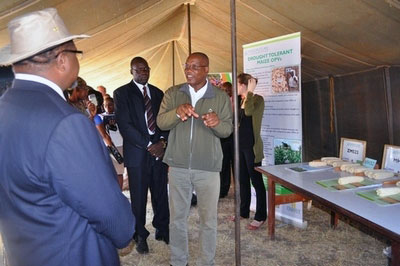 Dr. Peter Setimela (wearing fleece), CIMMYT–SARO Seed Systems Specialist, explains CIMMYT's work on drought-tolerant maize. In the next three years, CIMMYT hopes to reach 50,000 households in Malawi with drought-tolerant maize varieties to help smallholder farmers adapt to the impacts of climate change.