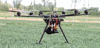 The DJI Spreading Wings S900 Hexo-copter fitted with an MKII Canon SLR Visual Camera flying over winter wheat near Wuzhong City, China. Photo: Jack McHugh/CIMMYT