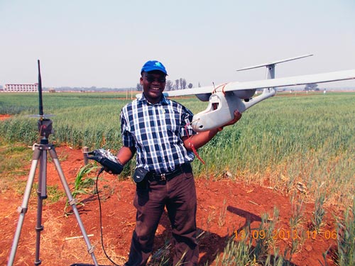 Charles Mutimaamba, Chief Research Officer and Maize Breeder at the CBI, pauses for a photo with the Skywalker in a field. Photo: Thokozile Ndhlela