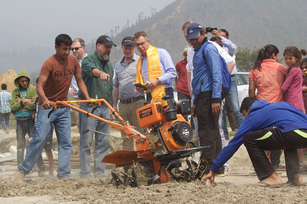 CIMMYT Director General Martin Kropff, observes a mini-tiller in operation during his visit in March this year to Nuwakot, one of the districts benefitting from the Earthquake Recovery Support Program in Nepal. Photo: A. Rai/CIMMYT