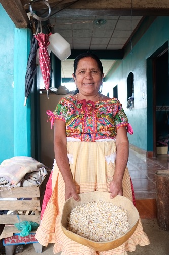 Felipa Martinez shows off some of her family's maize from last year's harvest. Photo: Matthew O'Leary
