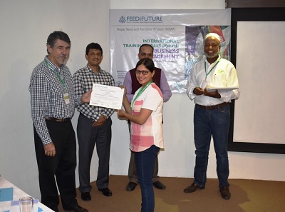 Suma Karki from Seed Quality Control Center (SQCC) of Nepal receiving certification of participation Photo: E. Kohkar/CIMMYT-Pakistan.